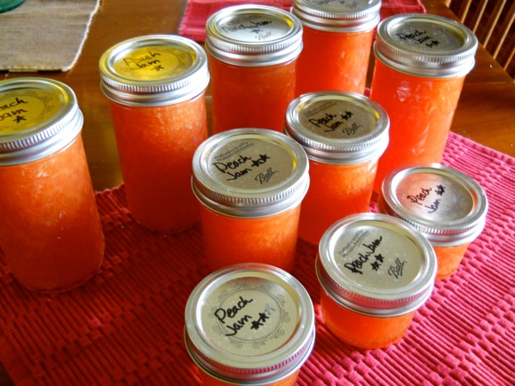 mason jars of peach jam with handwritten labels